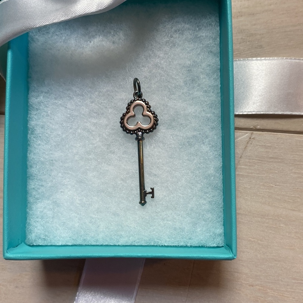 Authentic Tiffany & Co. sterling beaded trefoil key charm with Pink enamel. BNWB